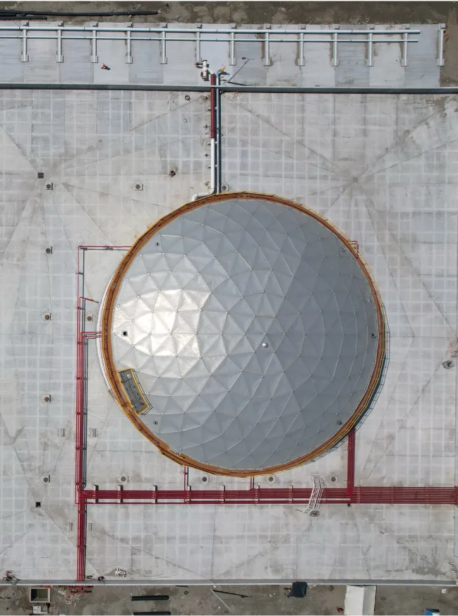 Aerial view of a large circular industrial storage tank.